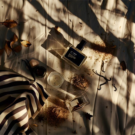 Perfume bottle on a textured surface with leaves and fabric for an eco-friendly house cleaning company